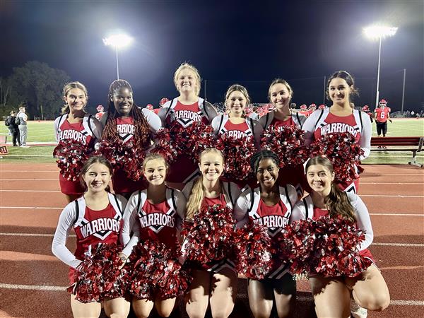Group photo of the cheerleading team at a home game