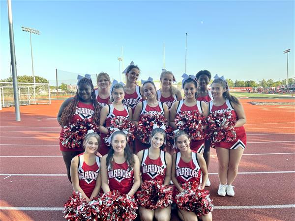 Cheerleading team poses at the first home game
