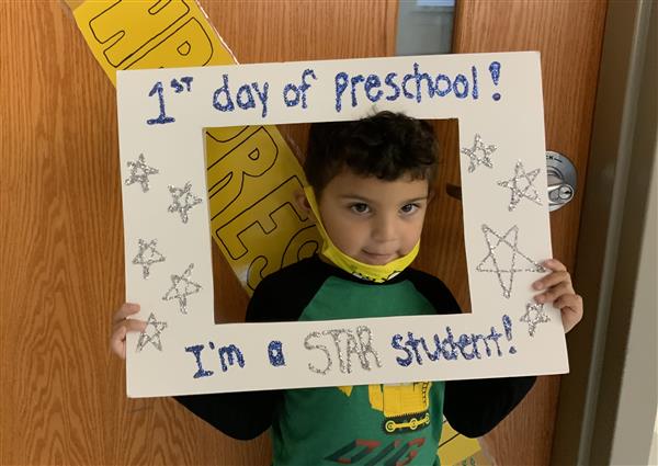 This picture is of KA on his first day of HP Preschool holding a first day sign.