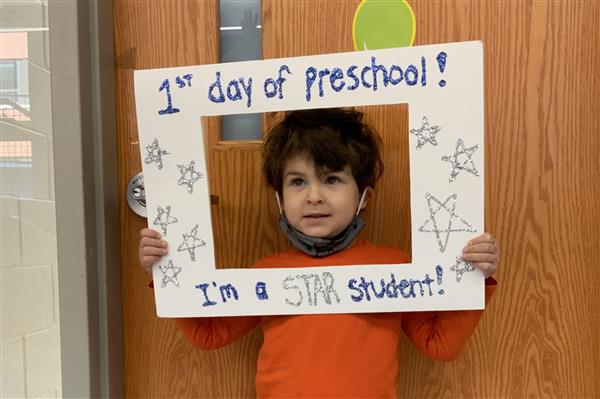 This picture is of JB on his first day of HP Preschool holding a first day sign.