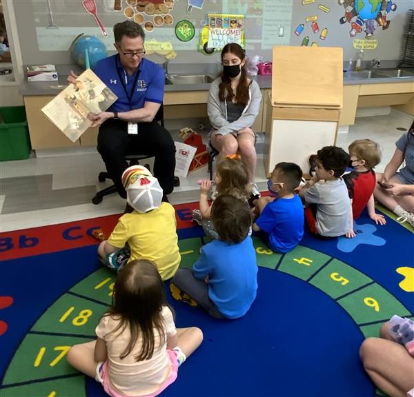 Dr. Law reads to the children at circle.