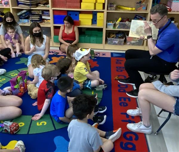 Dr. Law reads to the children at circle.