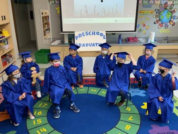 Preschool children graduate at circle time.