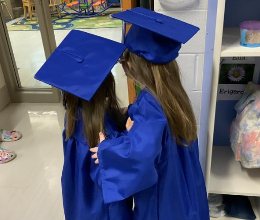 Best friends hug each other before graduation ceremony.